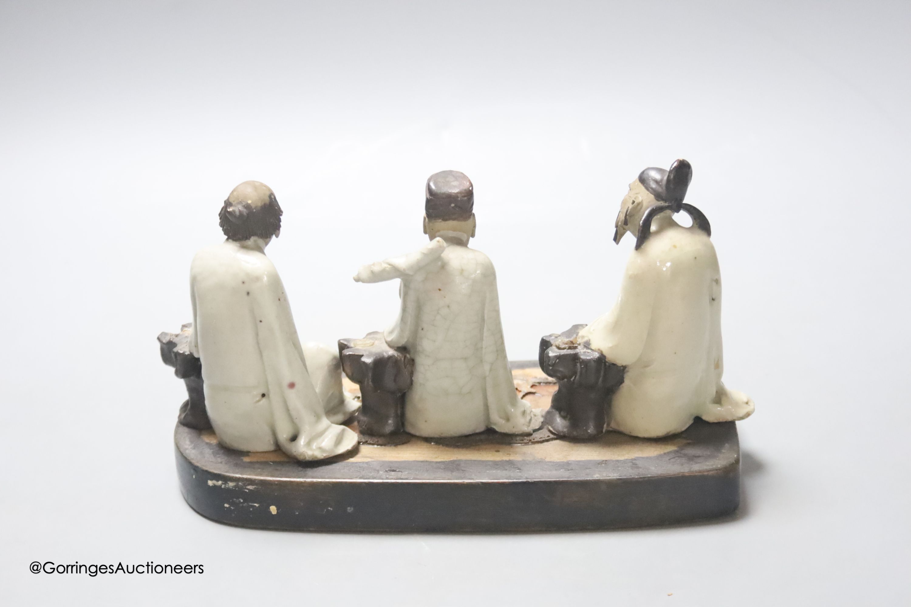 Three early 20th century Chinese stoneware figures of gentleman, height 9cm